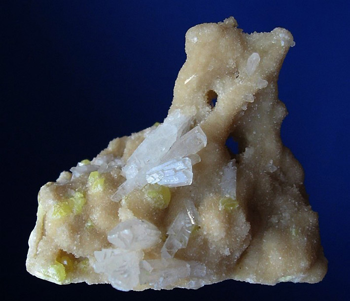 Cluster of big white celestine crystals on matrix consisting of tiny aragonite crystals and yellow sulfur from Tarnobrzeg in Poland