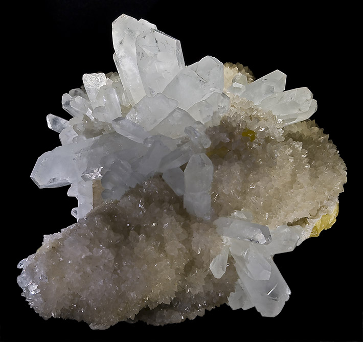 Elongated white celestine crystals on white aragonite and yellow sulfur from Miniera Florestella, Sicily, Italy