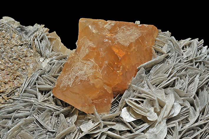 Crystals of orange scheelite on muscovite from Yaogangxian Mine, Hunan Province, China